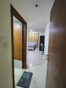 Paradise Living في فيصل آباد: ممر مع باب وغرفة مع أريكة