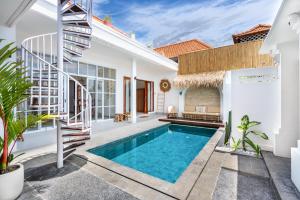 a villa with a swimming pool and a staircase at Boho Majipso Dreamy in Munggu