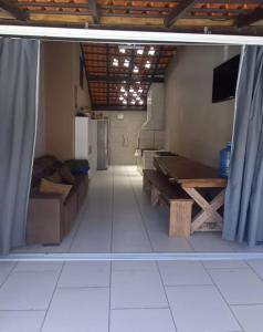 a living room with a couch and a table at HosteldaRo in Penha