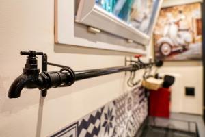 a water hose hooked up to a wall at Paris-Eiffel, bienvenue -terrasse -Netflix in Pantin