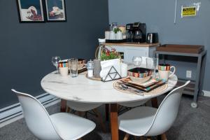 a dining room table with chairs and a white table at One-bedroom guest suite with private entry in Winnipeg