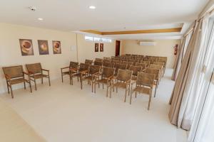 a room with rows of chairs in a classroom at Bali Mar Hotel in Natal +109 photos