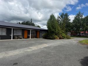 a building with a parking lot in front of it at Lumsden Motel in Lumsden