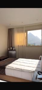 Ένα ή περισσότερα κρεβάτια σε δωμάτιο στο Sahary Pyramids View Hotel