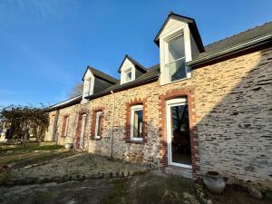 an old brick house with a driveway in front of it at Le grand Brandonné in Loiré