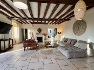 a living room with a couch and a table at Le grand Brandonné in Loiré