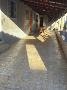a shadow of a building with a table on a patio at Suítes Santa Luzia in Trindade +6 photos