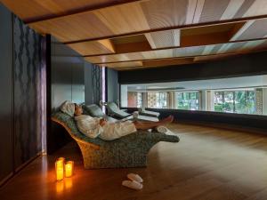 a woman laying on a couch in a living room at Swissotel Buyuk Efes Izmir in Izmir