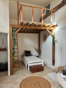 a bedroom with a bed and a loft bed with a ladder at Le grand Brandonné in Loiré +37 photos