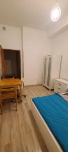 a bedroom with a bed and a table and a tv at Centrally located cozy apartment in Krakow +11 photos