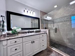 a bathroom with a sink and a shower at Destination #28 in Anaheim +21 photos