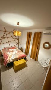 a bedroom with a bed and a lamp and a table at Nawalie in Pointe-à-Pitre