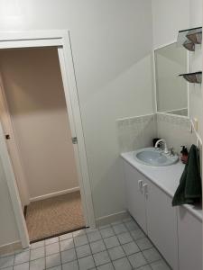 a bathroom with a sink and a mirror at Spacious 3 bdrm Unit, Rocky CBD in Rockhampton +7 photos