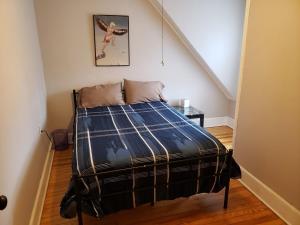 a bedroom with a bed with a plaid blanket at Grand Central - Pet friendly 3 BR 2 Bath in Johnson City