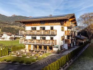 a large white building with wooden balconies at Bergzeit Hollersbach XL in Hollersbach im Pinzgau