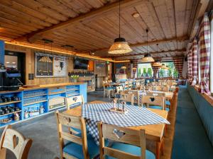 a dining room with tables and chairs in a restaurant at Bergzeit Hollersbach XL in Hollersbach im Pinzgau