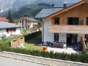 a house with a view of a house with a yard at Hirnreit in Leogang