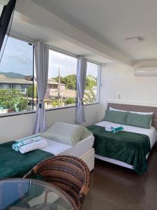 Ένα ή περισσότερα κρεβάτια σε δωμάτιο στο Pousada da Mel - Canasvieiras Floripa