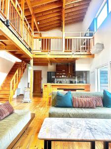 a living room with two couches and a staircase at Ajito Niseko in Kutchan