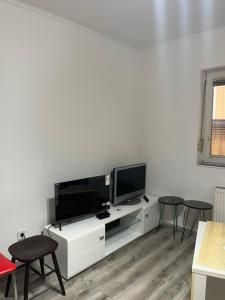 a living room with a tv on a white cabinet at Apartman Jovanović in Belgrade