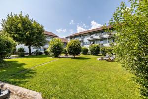 a building with a large lawn in front of it at Fewo Brünnstein - Zimmer 6 in Oberaudorf