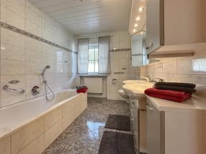a bathroom with a tub and a toilet and a sink at Sonnenwald in Zenting +23 photos