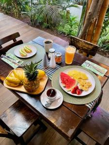a table with plates of food and fruit on it at Casa Santa Rosa Garden in Santa Rosa de Cabal +21 photos
