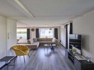 a living room with a couch and a tv at t Kaatsheuveltje 7 in Kaatsheuvel