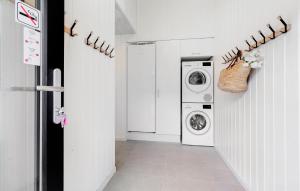 a white laundry room with a washer and dryer at Cozy Home In Glesborg With Sauna in Fjellerup