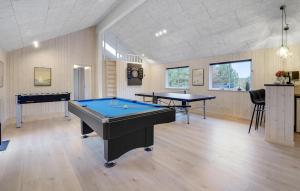 a room with two ping pong tables in it at Cozy Home In Glesborg With Sauna in Fjellerup
