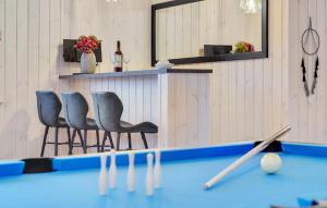 a pool table with two chairs in a room at Cozy Home In Glesborg With Sauna in Fjellerup