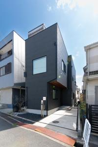 a black house on the side of a street at Kotohaku 南後背 in Kizu