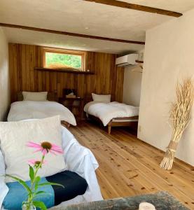 a room with two beds and a couch and a window at Private Forest Cottage for Two, Organic Lifestyle in Bungoono
