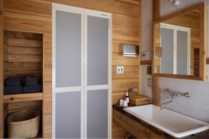a bathroom with a white sink and a mirror at Private Forest Cottage for Two, Organic Lifestyle in Bungoono +112 photos