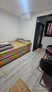 a room with a bed and a chair in it at Jolie Joes Standard Room with Private Bathroom in Tagudin