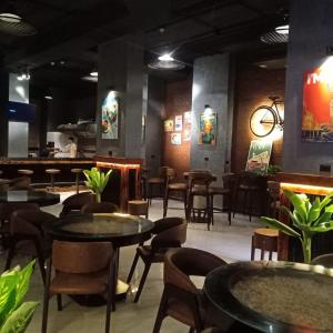 a restaurant with tables and chairs and a bar at Pyramids Gem Plaza Hotel in Cairo +210 photos