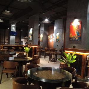 a restaurant with tables and chairs and a bar at Pyramids Gem Plaza Boutique Hotel & Restaurant in Cairo