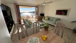 a living room with a table and a couch at Vistamar Porto Cristo in Porto Cristo