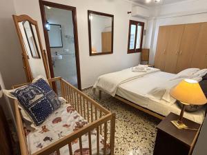 a bedroom with a bed and a chair and a mirror at Vistamar Porto Cristo in Porto Cristo