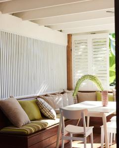 a living room with a couch and a table at Bruns Surf Shack in Brunswick Heads