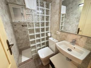a bathroom with a white toilet and a sink at Vistamar Porto Cristo in Porto Cristo +29 photos