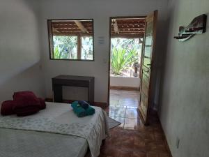 a bedroom with two beds and a doorway to a room at Pousada e Restaurante Morro Alto in São João Batista do Glória +26 photos