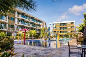 a pool at a hotel with a resort at Mana Beach Experience B019 in Porto De Galinhas