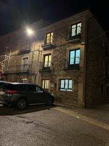 a car parked in front of a building at night at Casa Rural Piqueras in Almarza