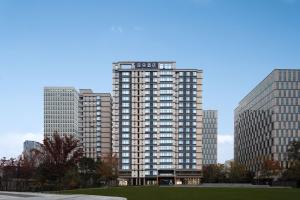 a tall building in a city with tall buildings at Atour Hotel Shanghai Wujiaochang Wanda Plaza in Shanghai