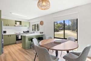 a kitchen and dining room with a table and chairs at Glenkeen Farm and Cabins in Bellbrae