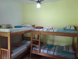 a room with three bunk beds in it at Pousada e Restaurante Morro Alto in São João Batista do Glória