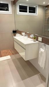 a bathroom with a white sink and a mirror at Espora 343 in Punta Alta