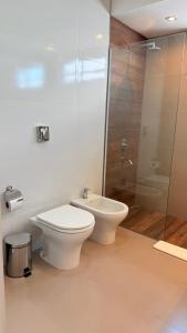 a bathroom with a toilet and a glass shower at Espora 343 in Punta Alta