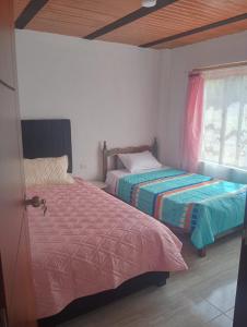 Ένα ή περισσότερα κρεβάτια σε δωμάτιο στο Finca La Esperanza Campestre Cucunuba